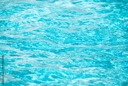 Background of blue water in swimming pool with sun reflection, ripple water wave in pool. Clear water background.