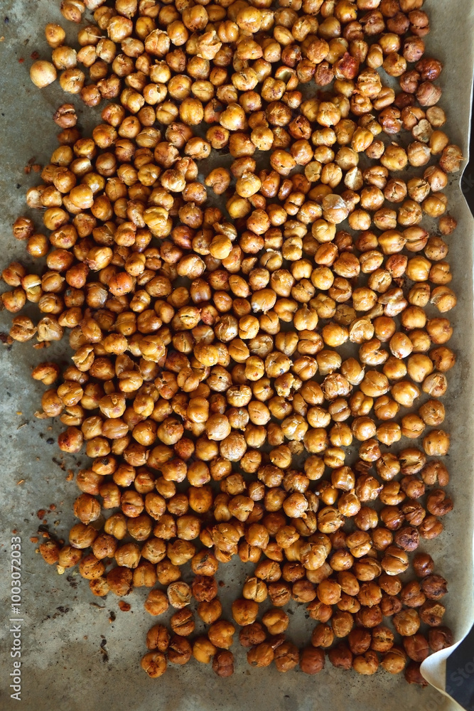 Sheet pan with homemade roasted chickpeas. Top view. Sheet pan with homemade roasted chickpeas. Top view.