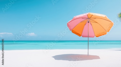 A colorful beach umbrella casting a shadow on the white sand, with a turquoise ocean and palm trees in the background.