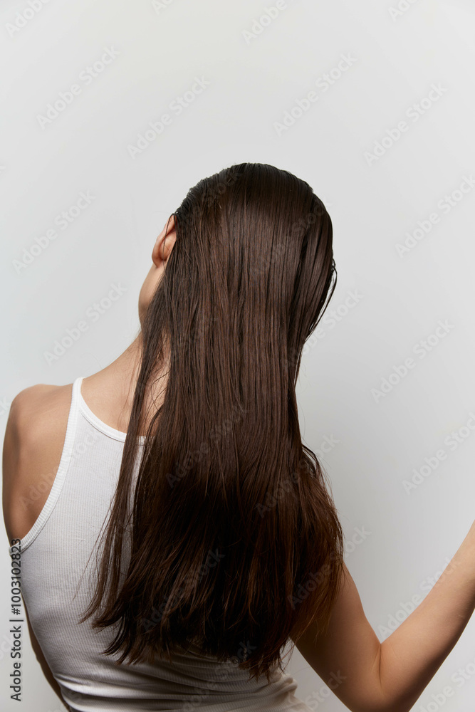 Long, shiny hair of a young woman against a minimalistic white background, showcasing hair textures and movement, emphasizing beauty and health concepts effectively Long, shiny hair of a young woman against a minimalistic white background, showcasing hair textures and movement, emphasizing beauty and health concepts effectively