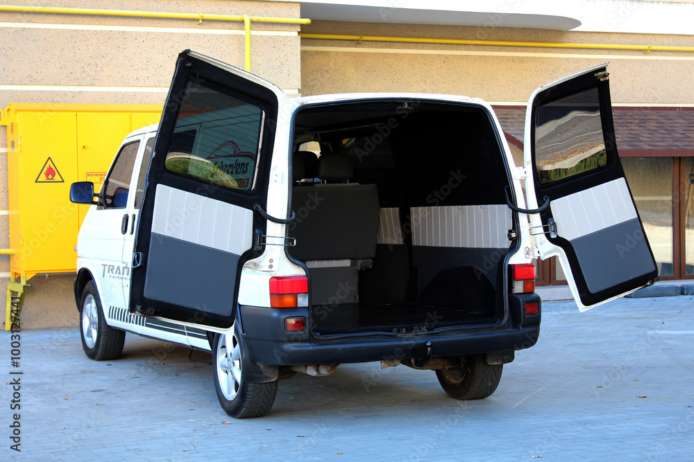 Van is ready for loading goods. Passenger van open trunk. Van Cargo open door trunk. Rear view modern van with open trunk and loading compartment. Open door trunk. Van is ready for loading goods. Passenger van open trunk. Van Cargo open door trunk. Rear view modern van with open trunk and loading compartment. Open door trunk.
