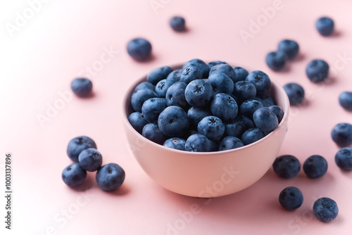 Blueberries in bowl with its fruit scattered isolated on pastel background