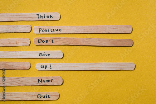 stick of ice cream with the words Think Positive, Don’t give up, Never quit. Motivational quotes, optimism, positive words. Isolated on background photo