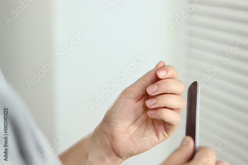 Close up of woman doing her nails at home, natural manicure  photo