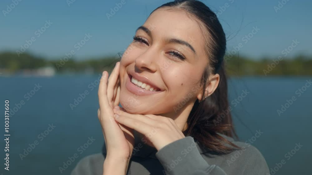 Bright teenage girl smiling at camera, embracing nature in the park. Bright teenage girl smiling at camera, embracing nature in the park.
