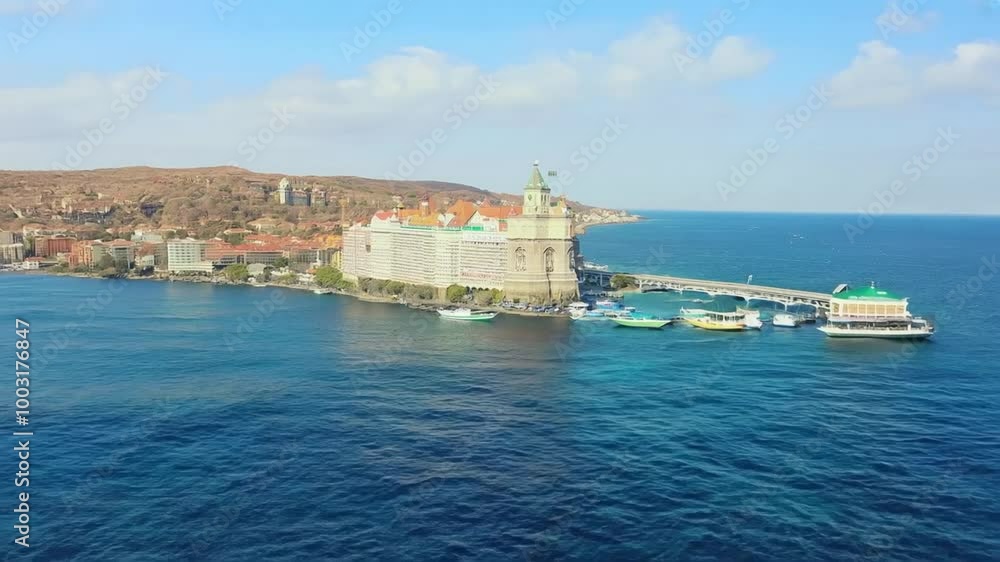 Boats entering a harbor near a picturesque coastal city on a sunny day create a serene atmosphere in slow motion Boats entering a harbor near a picturesque coastal city on a sunny day create a serene atmosphere in slow motion