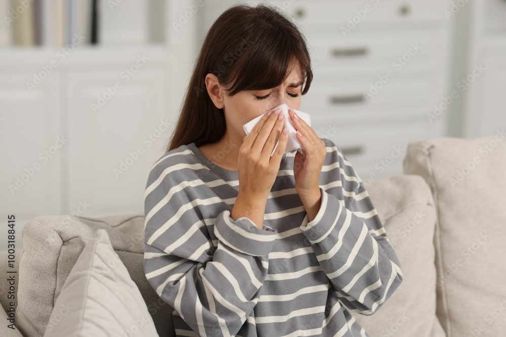 Woman with napkin suffering from sinusitis on sofa at home Woman with napkin suffering from sinusitis on sofa at home