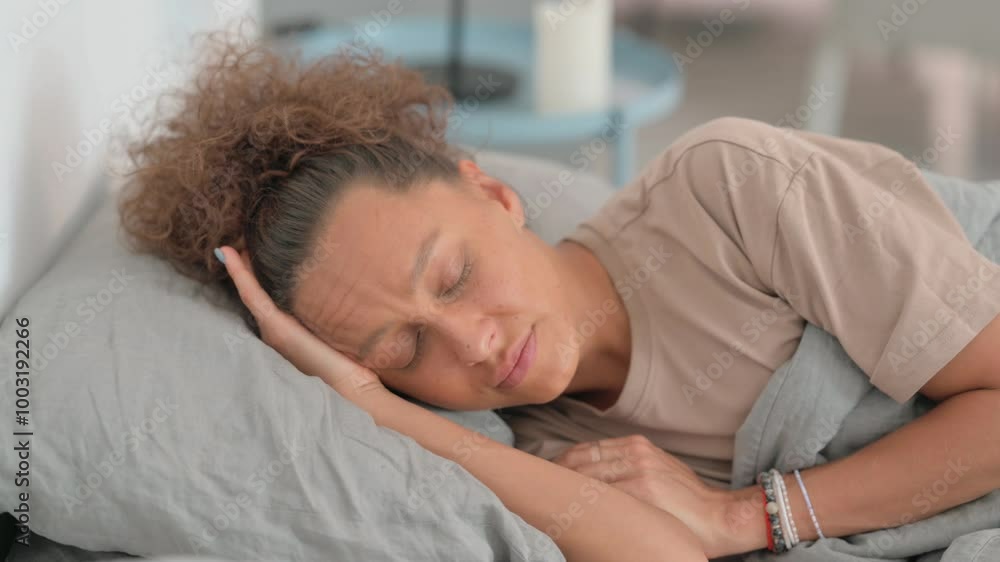 Tired Hispanic Woman Sleeping while Lying on Side in Bed Tired Hispanic Woman Sleeping while Lying on Side in Bed