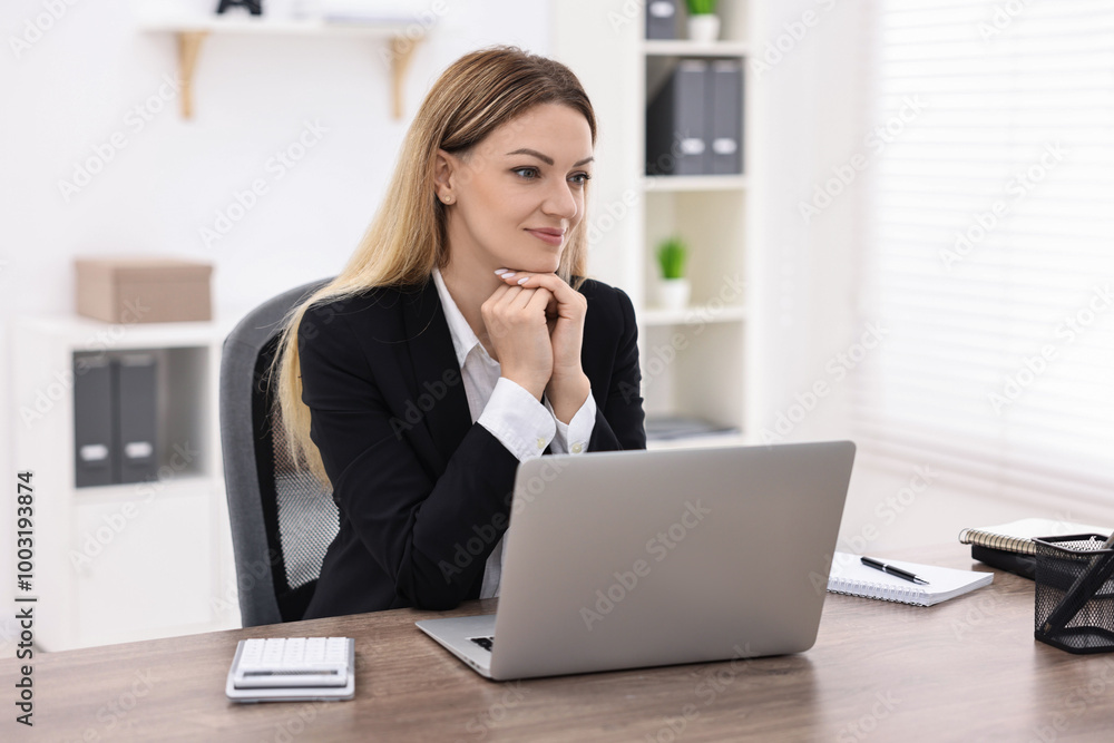 Banker with laptop working at wooden table in office Banker with laptop working at wooden table in office