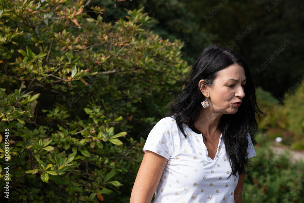 Midlife woman in nature, experiencing menopause, showing maturity and wisdom, displaying vitality, outdoor environment concept Midlife woman in nature, experiencing menopause, showing maturity and wisdom, displaying vitality, outdoor environment concept