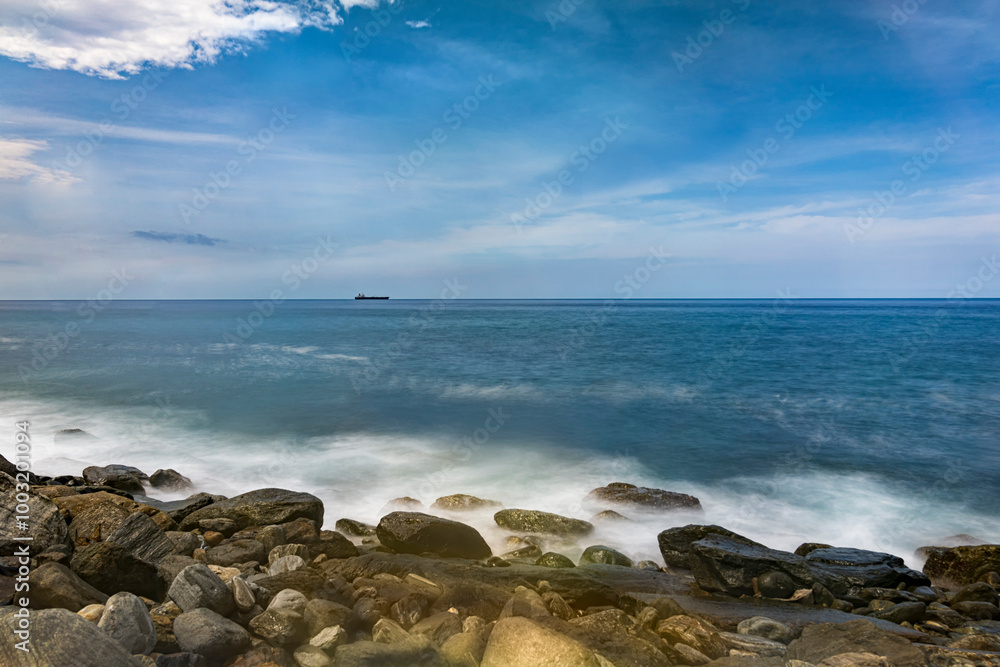 Long exposure of waves breaking on the shore.
