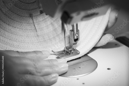 Close-up of a woman's hands sewing on a sewing machine with moving needle. handmade rope crafts