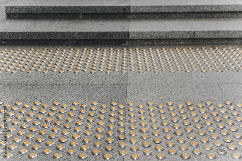 Obraz na płótnie Stainless steel tactile indicators set set on walkway and stairs, closeup. Anti-slip surface. w salonie