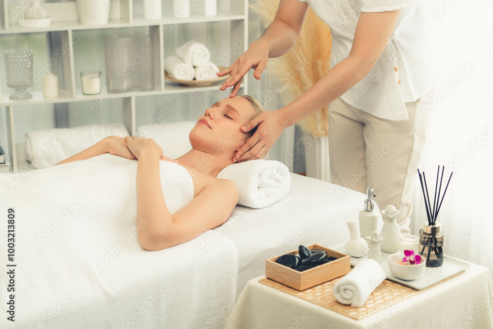 Obraz premium Caucasian woman enjoying relaxing anti-stress head massage and pampering facial beauty skin recreation leisure in dayspa modern light ambient at luxury resort or hotel spa salon. Quiescent