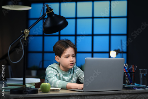Little boy with laptop doin...