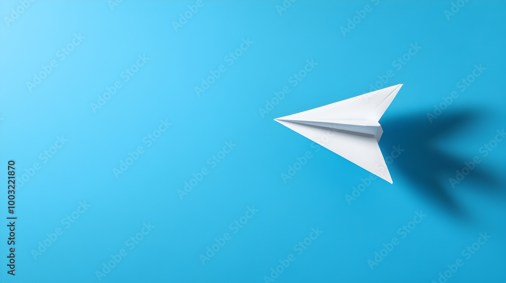 A light blue background with a floating paper airplane casting a shadow below. Paper airplane on a blue background.
A light blue background with a floating paper airplane casting a shadow below. Paper airplane on a blue background.