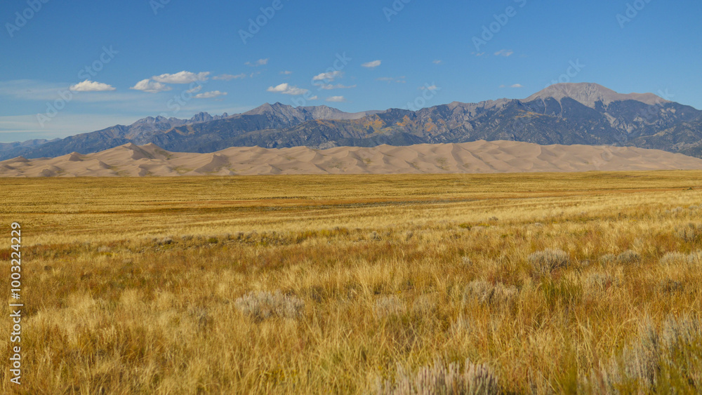Large sand dunes of Great Sand Dunes National Park in front of mountains in Colorado, USA Large sand dunes of Great Sand Dunes National Park in front of mountains in Colorado, USA