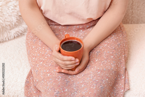 Woman holding warm coffee m...