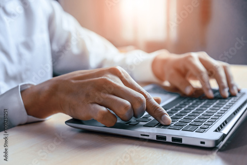 Businessman hand typing on computer keyboard of a laptop computer in office. Business and finance concept. uds