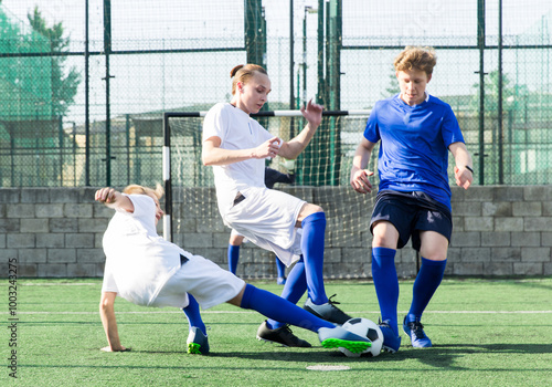 Teens playing soccer football match. Competition between two youth soccer teams. Football soccer tournament photo