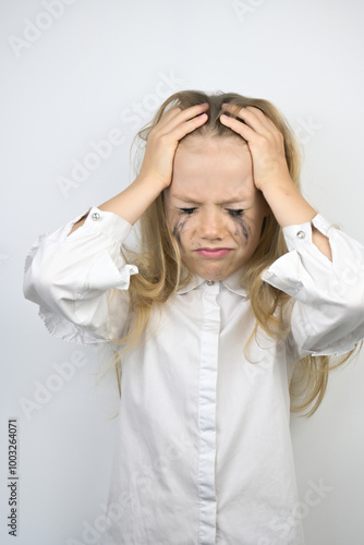 A little girl with brown disheveled hair on a white background. Leaky mascara, tears, anxiety, stress, bullying.