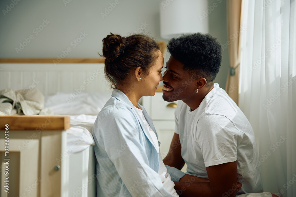 Obraz premium Young affectionate couple in their bedroom.