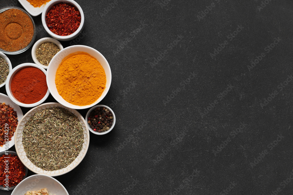 Composition with bowls of different aromatic spices on dark background Composition with bowls of different aromatic spices on dark background