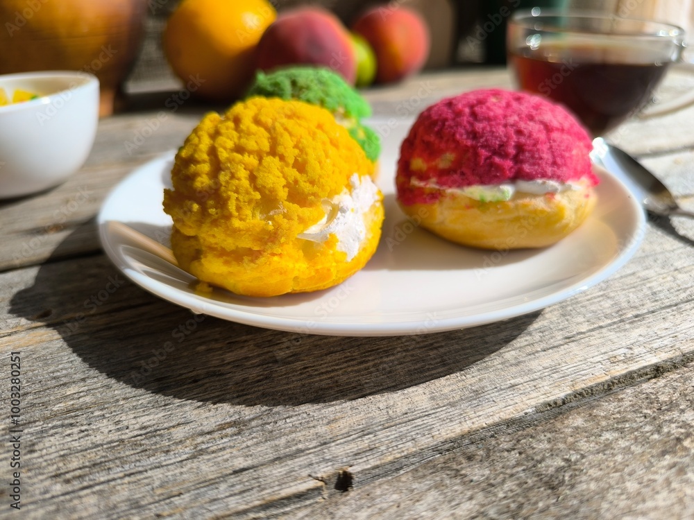 Three iced cakes on a plate. High-quality photos Three iced cakes on a plate. High-quality photos