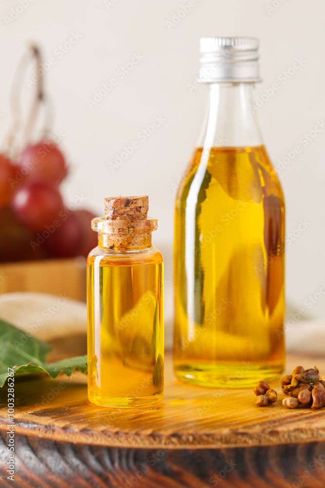 Bottles of cosmetic grape seed oil on white background Bottles of cosmetic grape seed oil on white background
