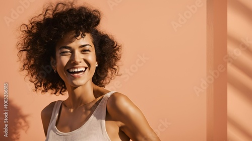 Smiing woman against peach color background photo