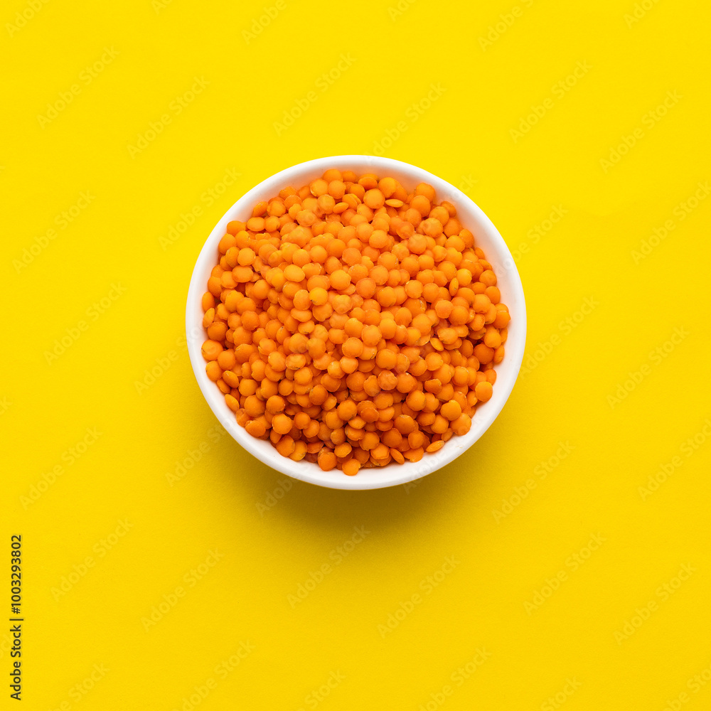Lens culinaris - Raw red lentils in a bowl. Lens culinaris - Raw red lentils in a bowl.