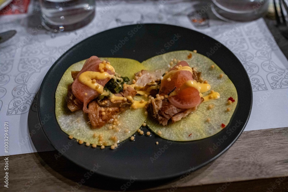 delicious looking tacos topped with pork belly, veggie garnish, and sauces delicious looking tacos topped with pork belly, veggie garnish, and sauces