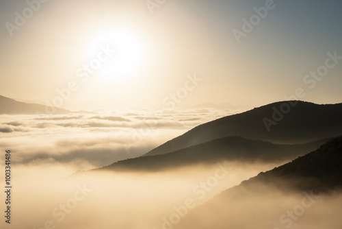 Amber sunrise above low clo...