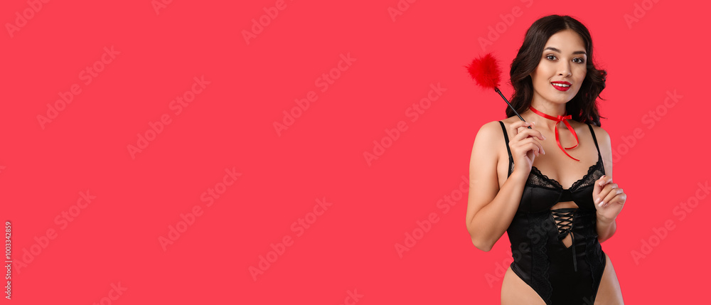 Beautiful young Asian woman in sexy underwear with feather stick on red background Beautiful young Asian woman in sexy underwear with feather stick on red background