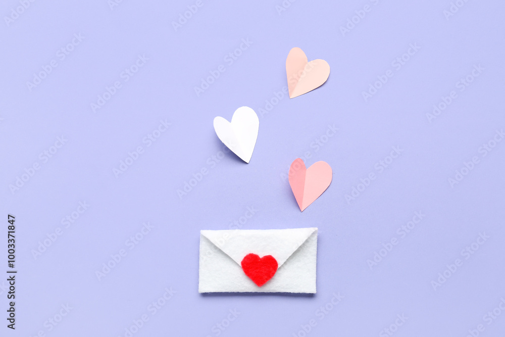 Composition with paper hearts and envelope for Valentine's Day on grey background