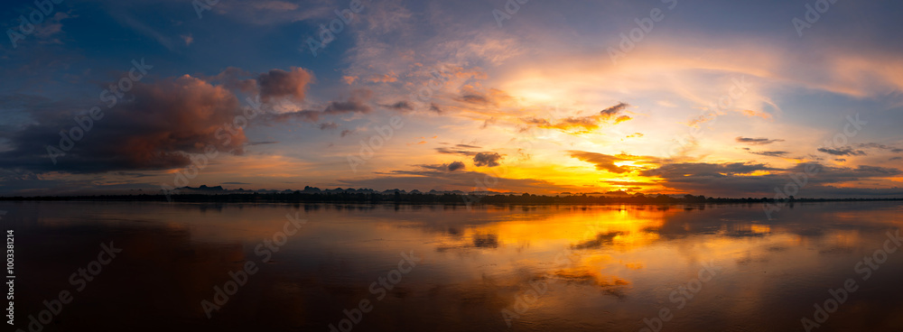 Panorama Reflection of vivid sunset sky reflection in water.Colorful sunrise with Clouds over Mekong River , Nakhon Phanom province,Thailand,ASIA. Panorama Reflection of vivid sunset sky reflection in water.Colorful sunrise with Clouds over Mekong River , Nakhon Phanom province,Thailand,ASIA.