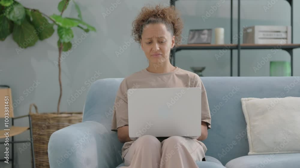 Hispanic Woman Shocked by Loss while Reading Documents on Sofa Hispanic Woman Shocked by Loss while Reading Documents on Sofa