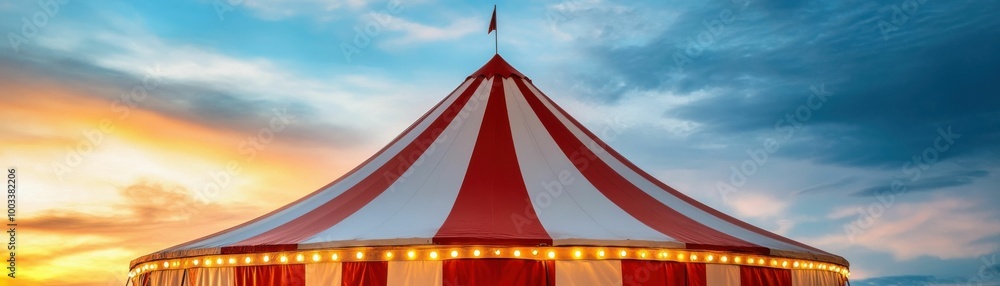 A large red and white striped circus tent glowing under a beautiful golden sunset sky, creating a festive outdoor atmosphere.. A large red and white striped circus tent glowing under a beautiful golden sunset sky, creating a festive outdoor atmosphere..