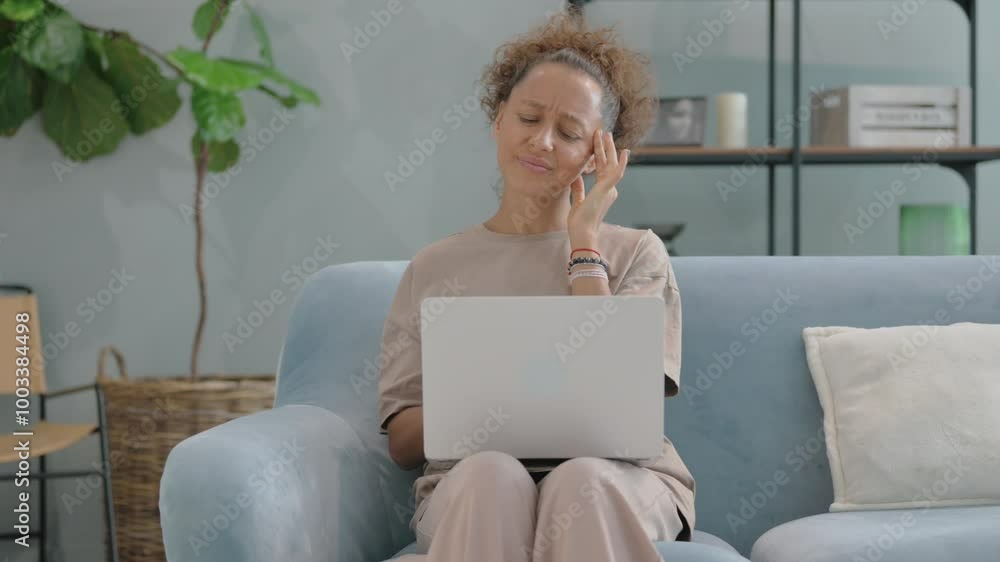 Hispanic Woman with Headache Using Laptop at Home Hispanic Woman with Headache Using Laptop at Home