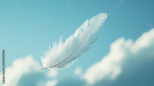 A delicate white feather floating against a serene blue sky with soft clouds.