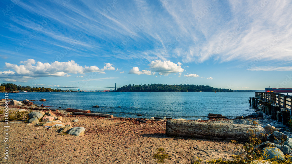 View from beach at Ambleside, West Vancouver, BC, to Stanley Park with Lionsgate Bridge visible on left horizon. View from beach at Ambleside, West Vancouver, BC, to Stanley Park with Lionsgate Bridge visible on left horizon.