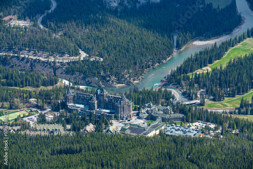 View of the stunning Fairmont Banff Springs Hotel in the town during spring time with incredible views surrounding the wilderness hotel in Canada. photo