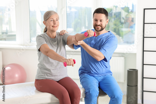 Senior patient exercising under physiotherapist supervision in rehabilitation center