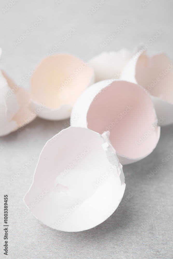Broken eggshells on grey textured table, closeup Broken eggshells on grey textured table, closeup