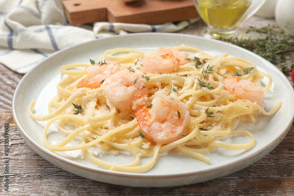Delicious pasta with shrimps on wooden table, closeup Delicious pasta with shrimps on wooden table, closeup