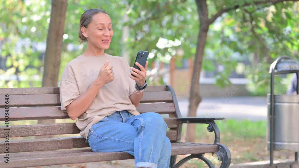 Young Hispanic Woman Doing Online Video Talk on Smartphone Young Hispanic Woman Doing Online Video Talk on Smartphone