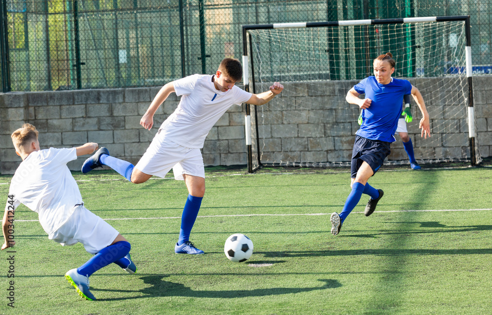 Fototapeta premium Football player swings his leg for kick in direction of goal