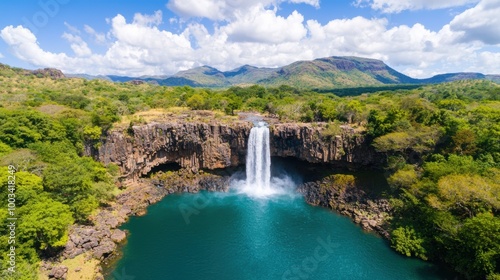 Stunning waterfall cascading into a clear turquoise pool surrounded by lush greenery.