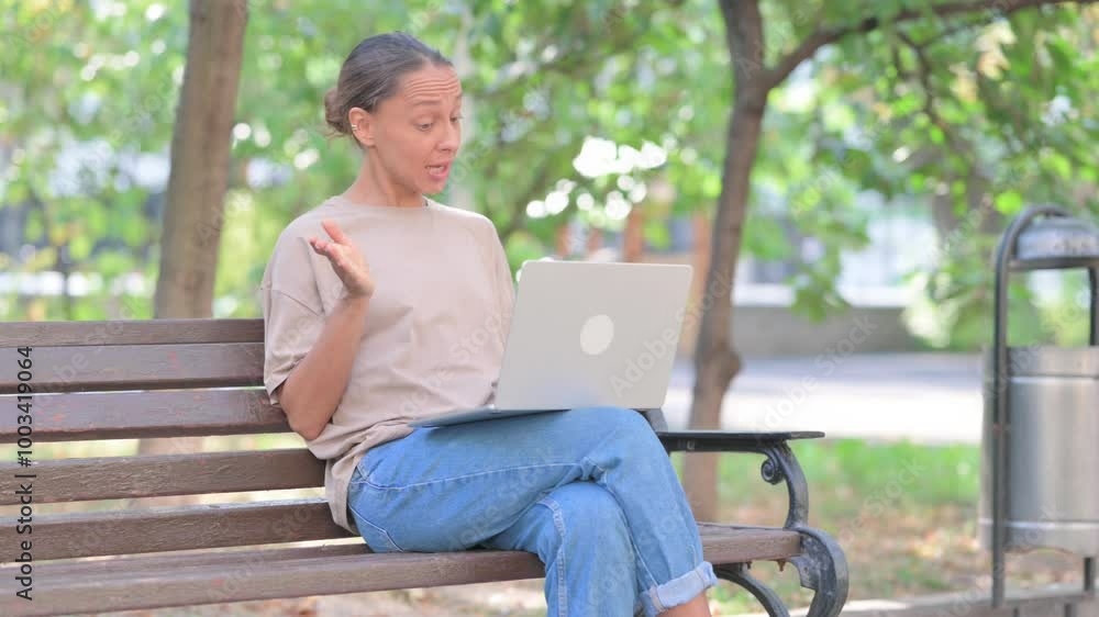Online Video Chat on Laptop by Young Hispanic Woman Sitting Outdoor Online Video Chat on Laptop by Young Hispanic Woman Sitting Outdoor