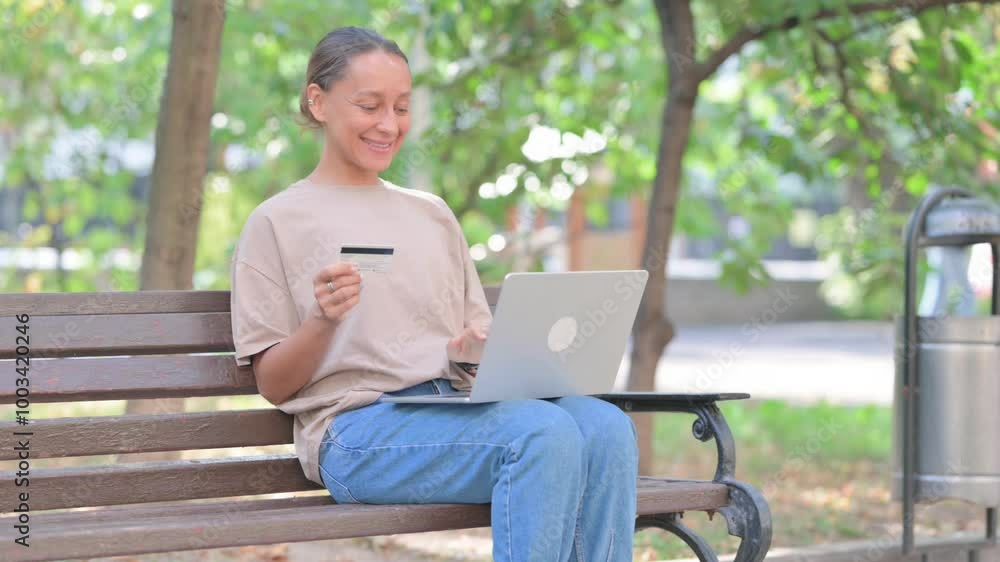 Young Hispanic Woman Enjoying Online Banking with Credit Card Outdoor Young Hispanic Woman Enjoying Online Banking with Credit Card Outdoor
